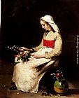 A Girl Arranging A Vase Of Flowers by Theodule Augustine Ribot